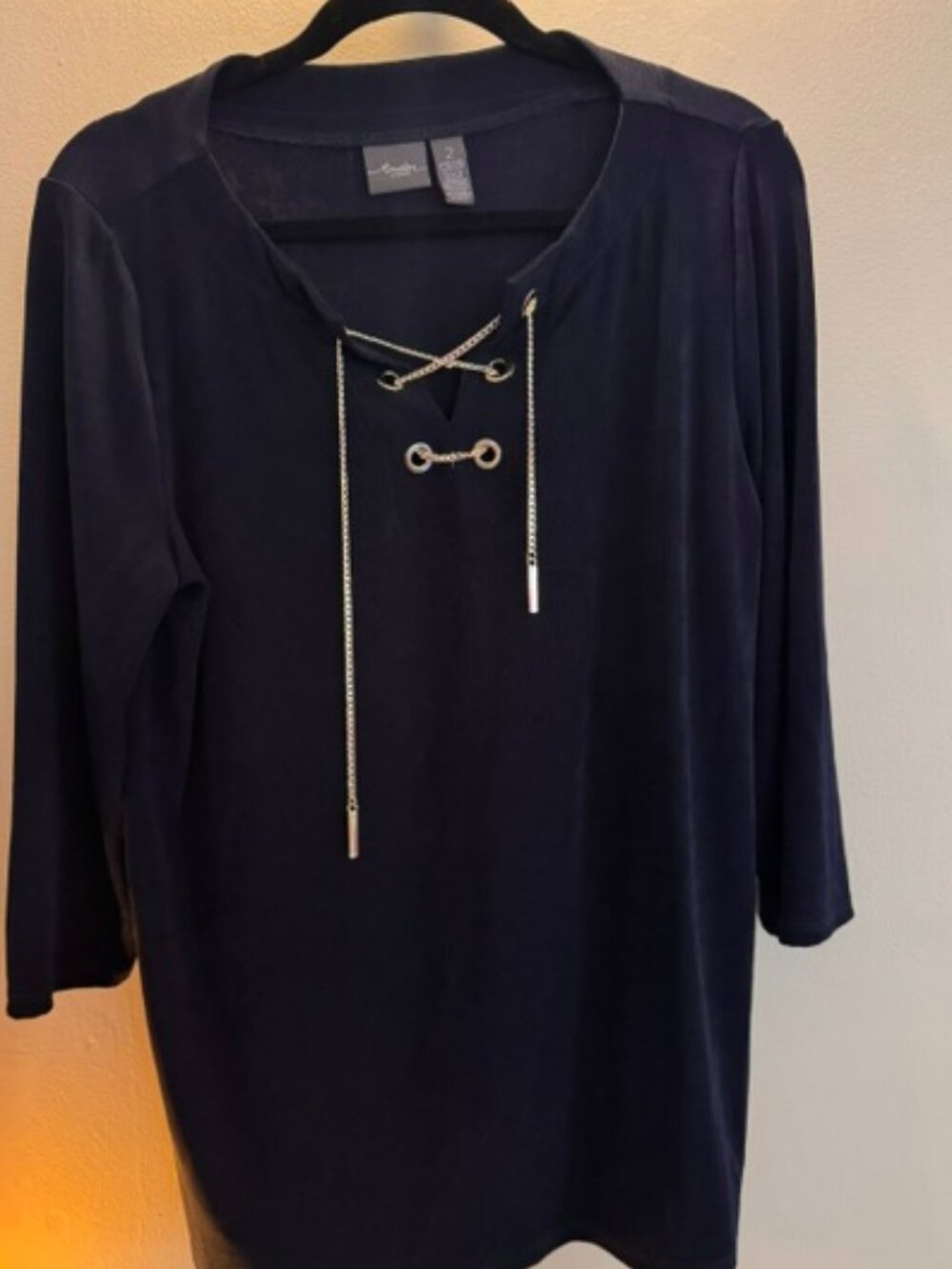 Chico's Travelers top features a V-neckline with gold chain lace-up detail